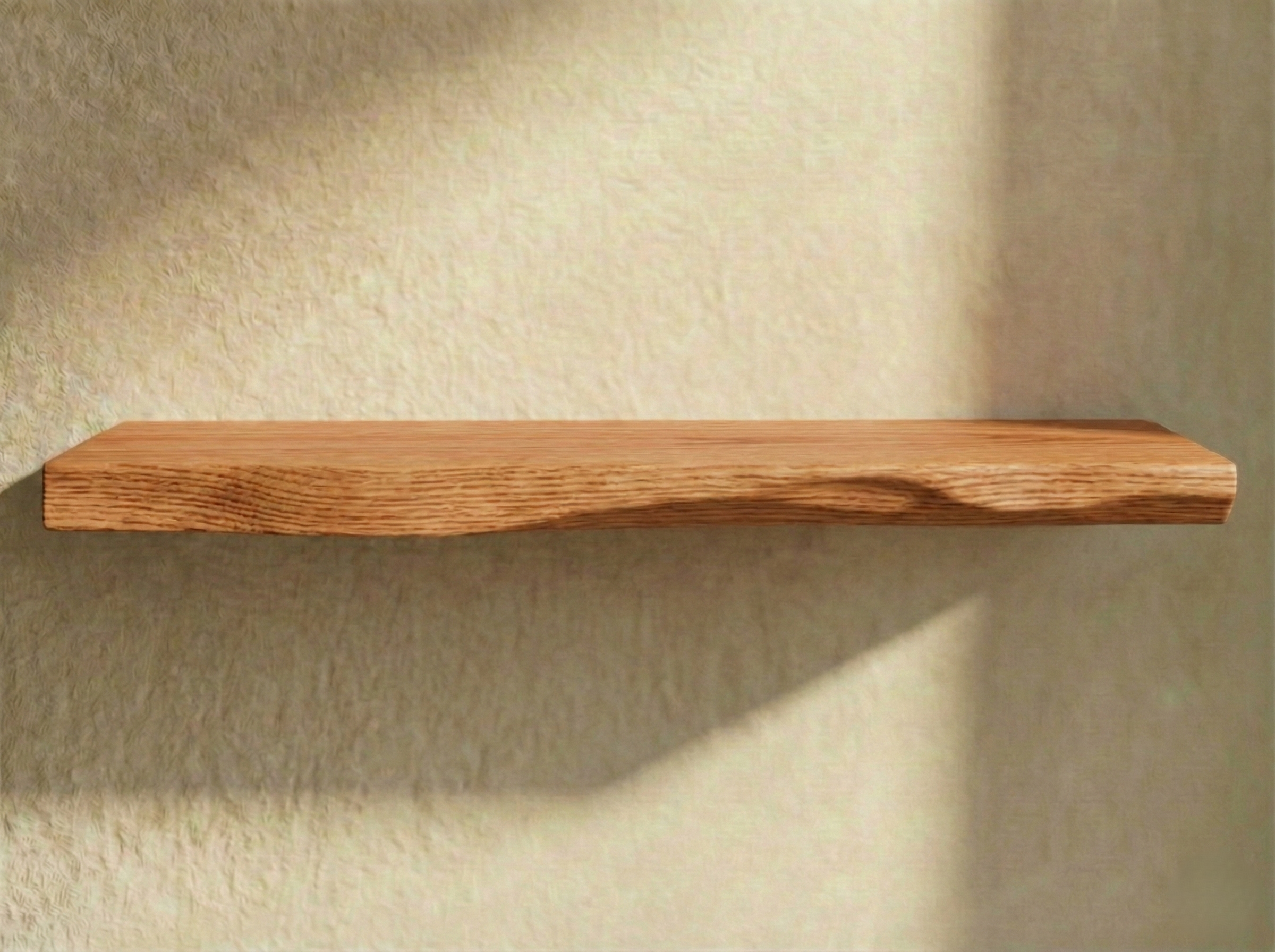 Solid red oak live edge floating shelf showcasing unique grain patterns and natural wood finish.