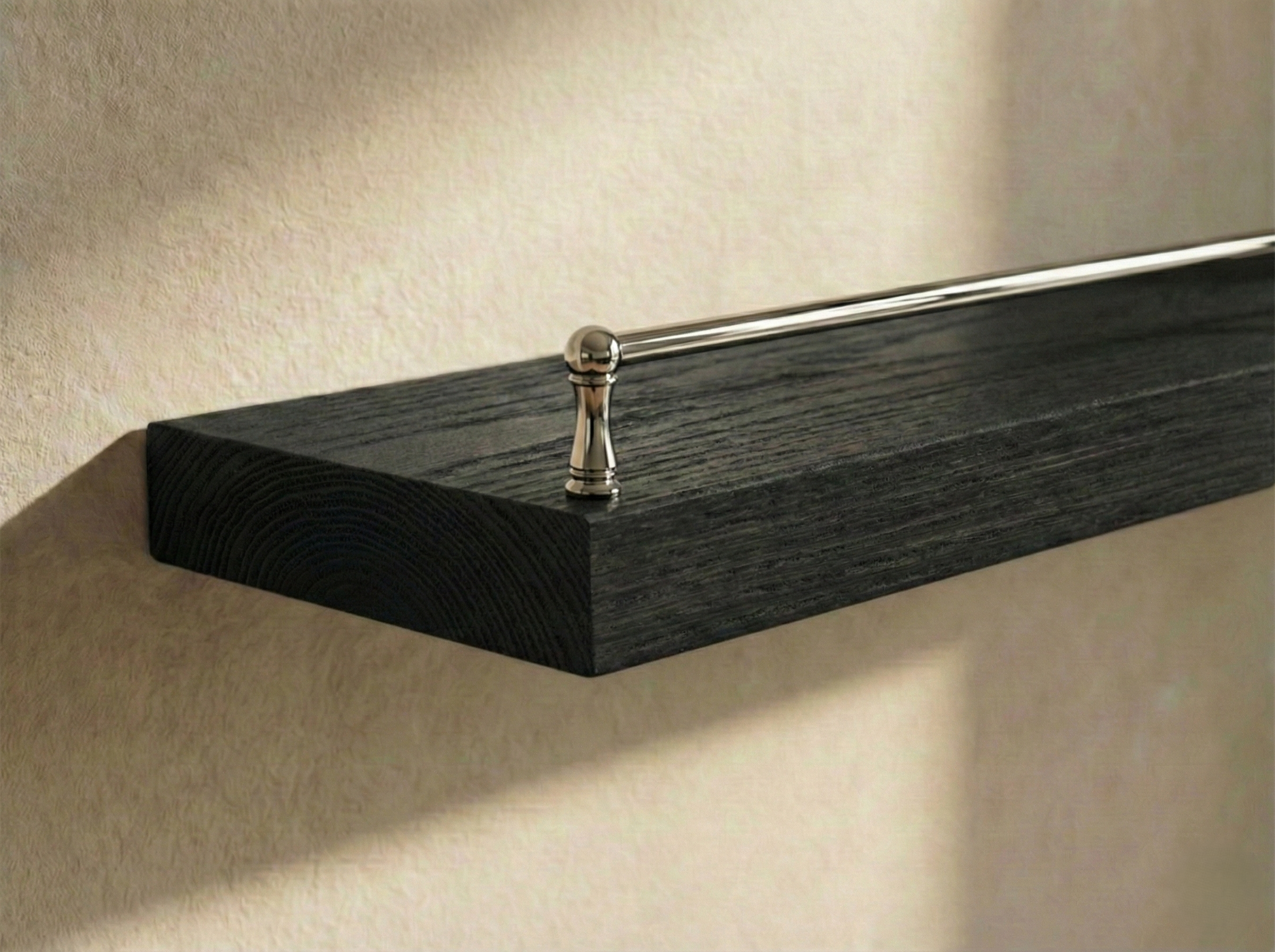 Solid black oak floating shelf with gallery rail from Shelving, showcasing a sleek, modern design with sturdy construction.