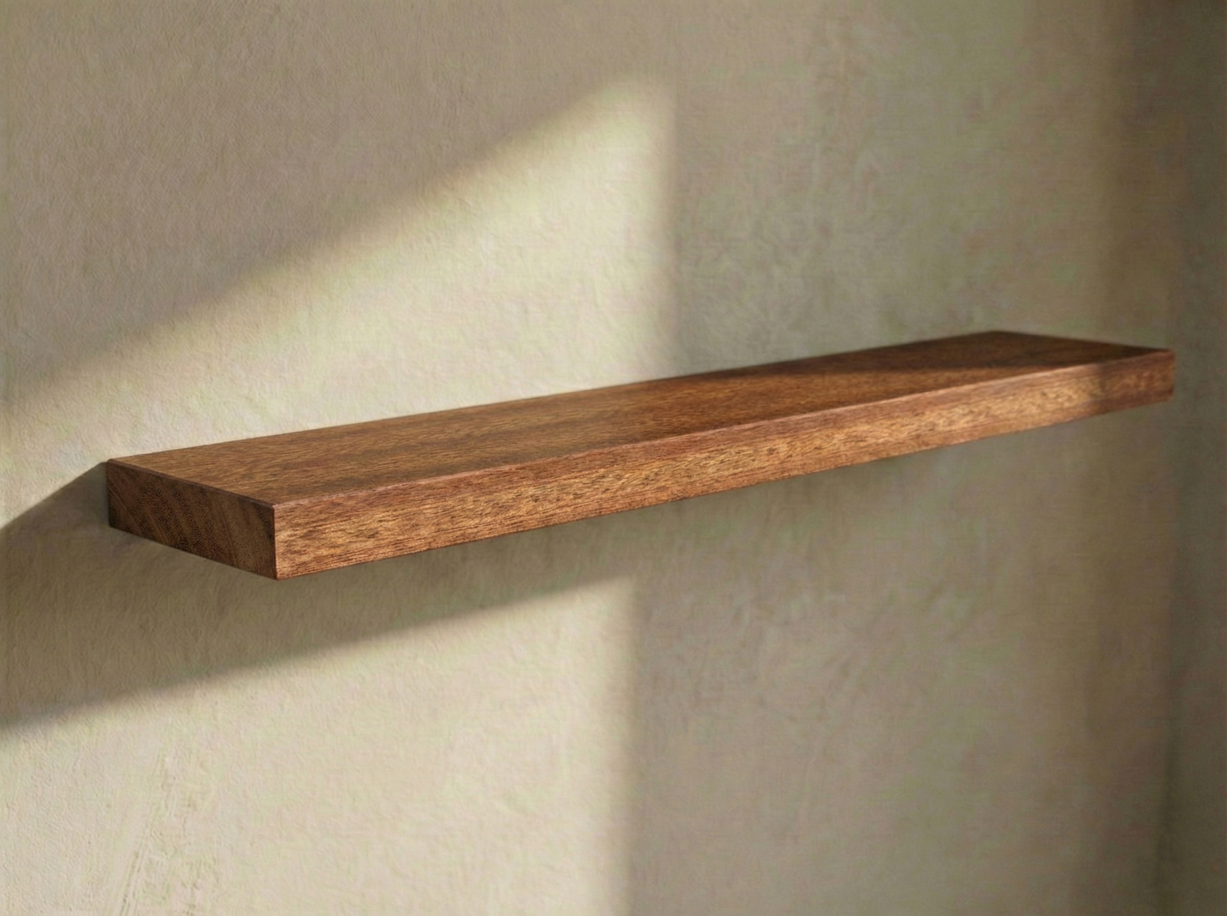 Solid mahogany floating shelf showcasing rich wood grain, perfect for modern wall decor and storage solutions.