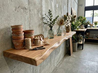Solid red oak live edge floating shelf by Shelving, showing its natural wood grain and sleek, modern design with hidden mounting.