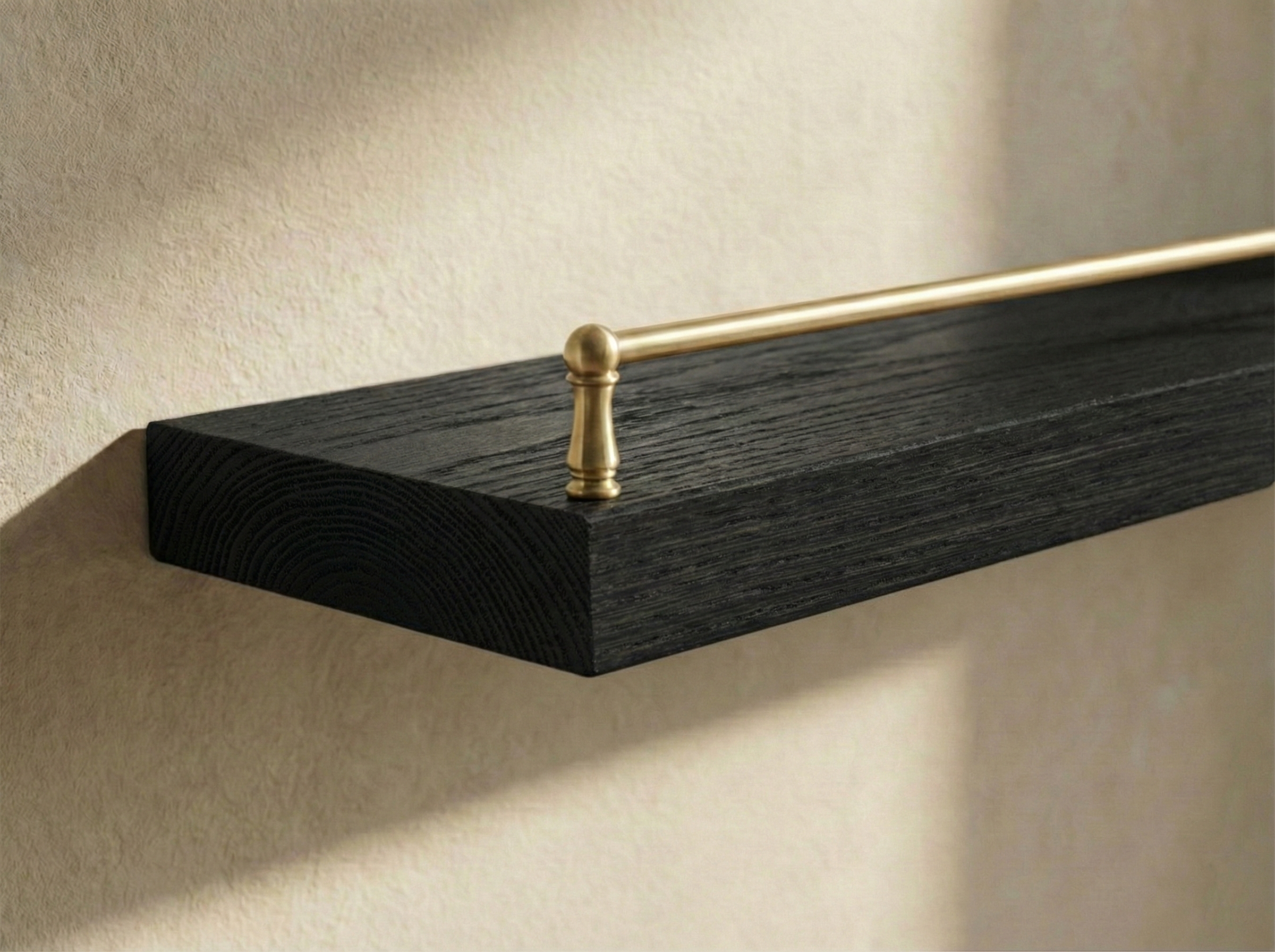Solid black oak floating shelf with gallery rail from Shelving, showcasing a sleek modern design for wall storage.
