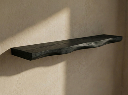 Solid black oak live edge floating shelf from Shelving displaying unique wood grain and natural edges.